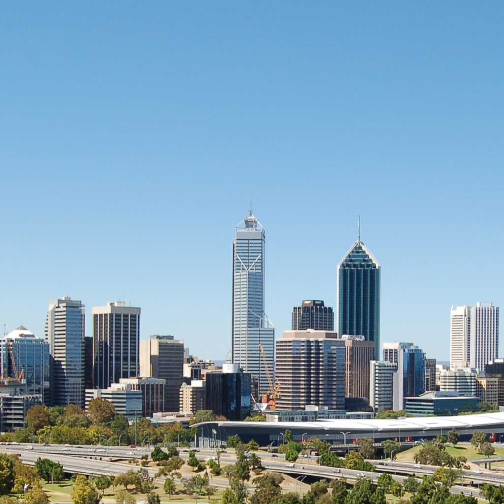 The Perth city skyline with high-rise towers, the freeway and parkland in the foreground.