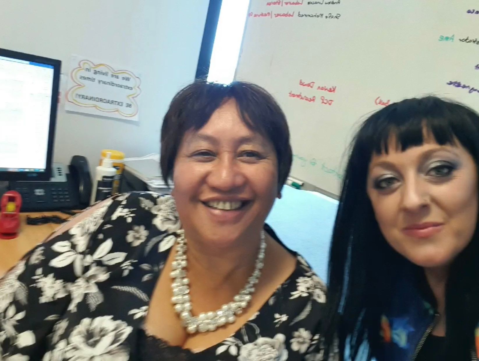 Two IRP team members smiling together in the office.
